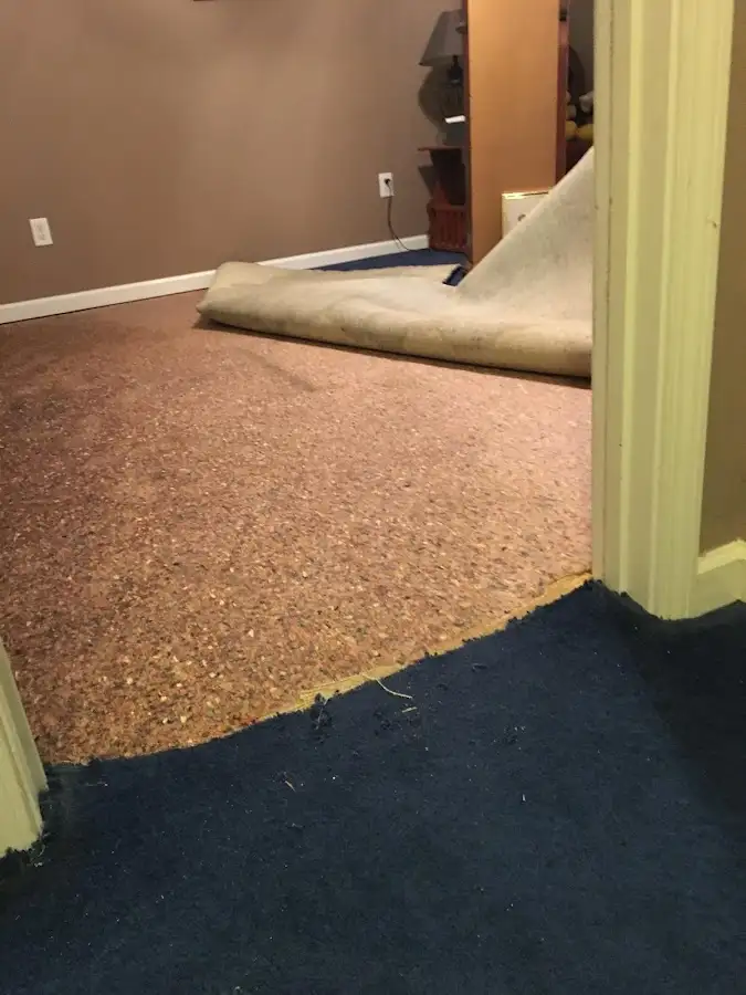 Carpet pad removal revealing water damage during Water Mitigation Services in Bakersfield